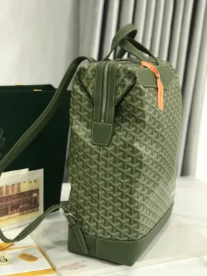 Goyard Cisalpin Backpack in green Goyardine canvas with structured zipper closure and orange accents, designed for urban adventurers and commuting.