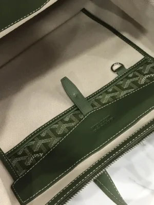 Interior view of Goyard Cisalpin Backpack showcasing green lining, zipper pocket, and signature Goyardine canvas pattern, emphasizing spacious design for urban adventurers.