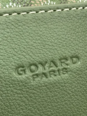Goyard Cisalpin Backpack detail showcasing embossed "Goyard Paris" logo on green calf leather.