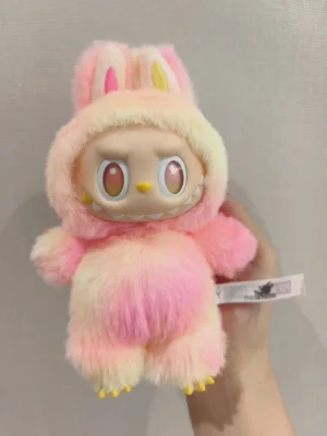 The Mengers plush toy pink and yellow gradient faux fur with expressive large eyes and bunny ears