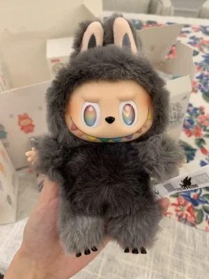 Pop Mart Labubu plush toy with colorful eyes and bunny ears, showcasing its soft, furry texture, held in hand against a floral background, representing luxury replica accessories available for purchase.