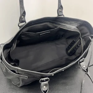 Interior view of the Balenciaga Vintage Horizontal Motorcycle Bag showcasing black leather texture, zippered compartments, and spacious design for versatile use.