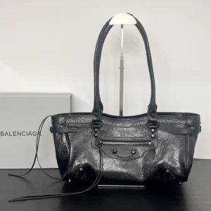 Black leather Balenciaga Le City Horizontal Motorcycle Bag on display, showcasing vintage hardware and textured finish, with a stylish design suitable for various outfits.