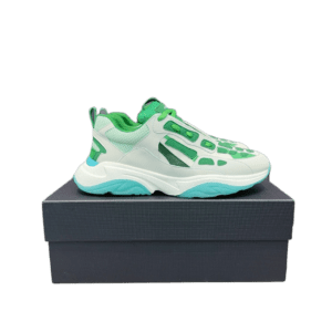 Amiri Trainer sneakers in white and green colorway displayed on a black box, showcasing a modern design ideal for luxury footwear enthusiasts.