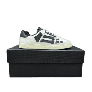 AMIRI Trainer sneakers in white and black colorway displayed on a black shoe box, showcasing luxury replica footwear design.