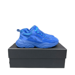 AMIRI Trainer sneakers in vibrant blue color displayed on a black shoe box, emphasizing luxury design and style.