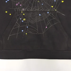 No visible brand or product model details, black fabric with spiderweb and colorful star design print on sweatshirt material