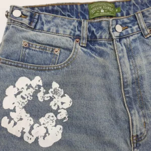 Denim Tears denim jeans blue cotton with white flower graphic and green label patch
