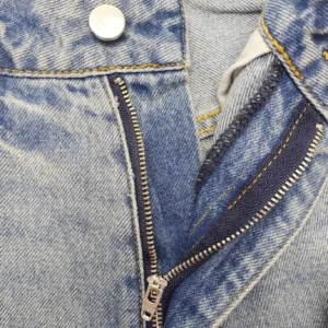 Levi's 501 original fit blue denim jeans with metal button and zipper closure close-up