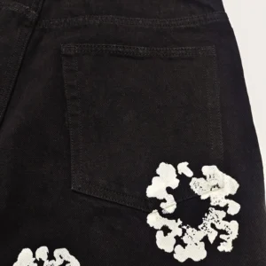 Unknown brand black denim pants with white floral paint design and back pocket detail