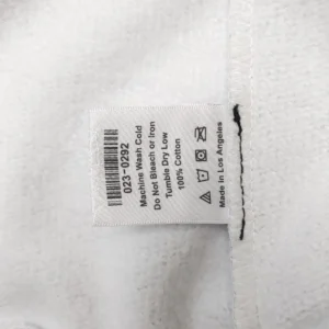 No product image is shown; the image depicts a clothing care label with washing instructions and material information.