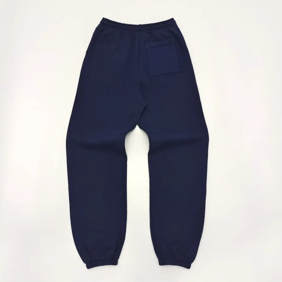 No brand visible sweatpants navy blue cotton with elastic waistband and ankle cuffs, single back pocket
