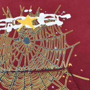 No brand, model, or product type visible; image shows red fabric with yellow and white star and web pattern design.