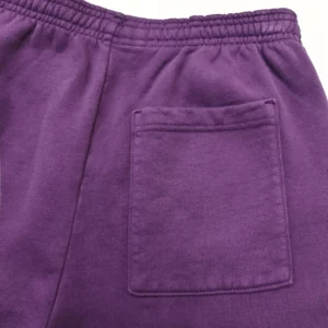 Deep purple sweatpants featuring an elastic waistband and a single back pocket, showcasing the fabric texture and color relevant to Sp5der clothing.