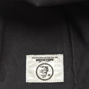 Hellstar clothing tag black fabric with white stitched logo patch featuring flames and star design
