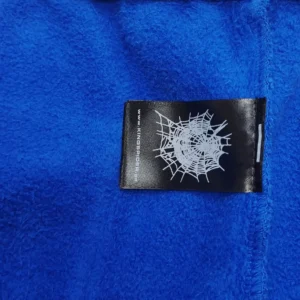 Kingspider fleece jacket blue soft textured fabric with branded black white spiderweb label