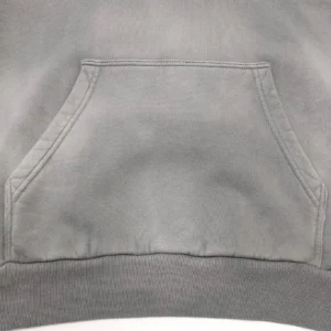 Cannot generate alt text with brand, model, or other details based on this close-up image of a plain gray fabric pocket and hem.