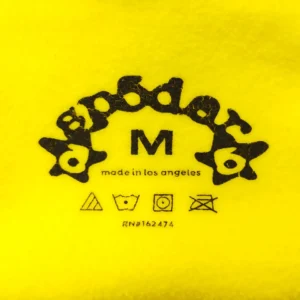 Astroboy fleece jacket M size bright yellow soft fabric with black printed logo and care instructions