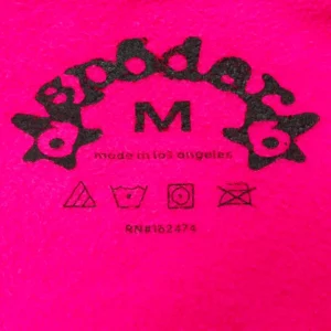 SDER logo and care label on a bright pink hoodie, featuring "M" size indicator and "made in Los Angeles" text, showcasing quality and brand details for the SDER Rose Red Hot Diamond White Word Legacy Hoodie.