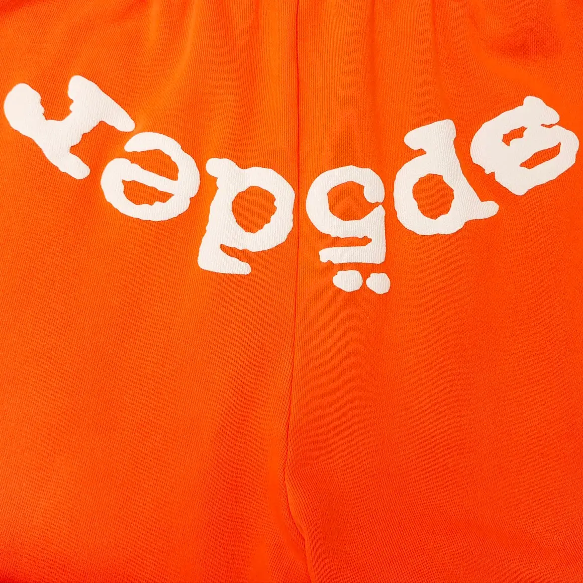 Repsgoat cotton fabric orange with white graphic print clothing material close-up detail