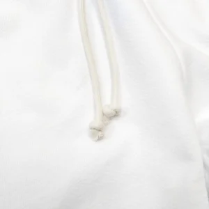 No brand or model information visible; close-up of white hoodie fabric with drawstring cords