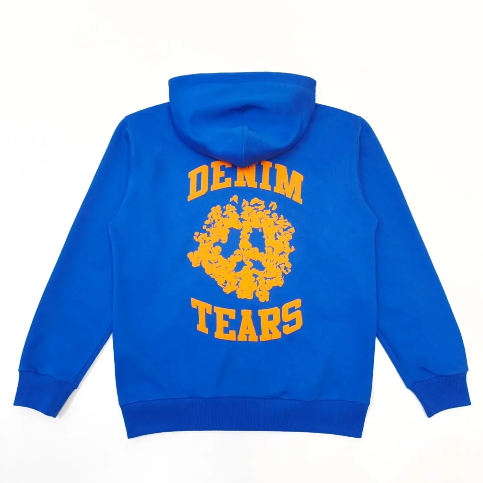 Denim Tears hoodie blue cotton fleece with orange floral peace sign graphic and text on back