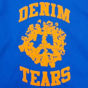 Denim Tears sweatshirt blue cotton fabric with orange floral peace sign graphic and typography design