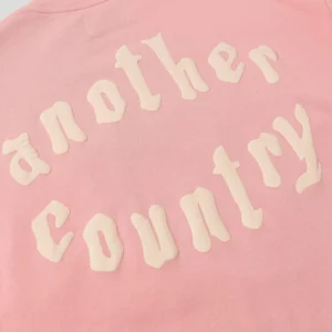 Another Country sweatshirt pink cotton fleece with cream textured logo lettering