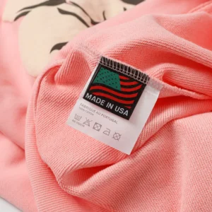 No visible brand or model details for SEO alt text; close-up of pink cotton fabric tag stating made in USA.