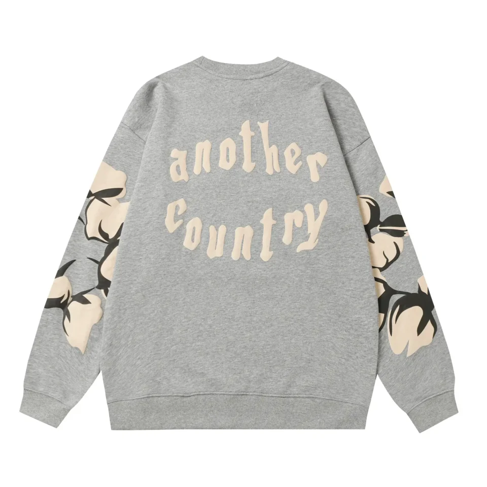 Another Country sweatshirt gray cotton crewneck with graphic cotton flower prints on sleeves and back text logo