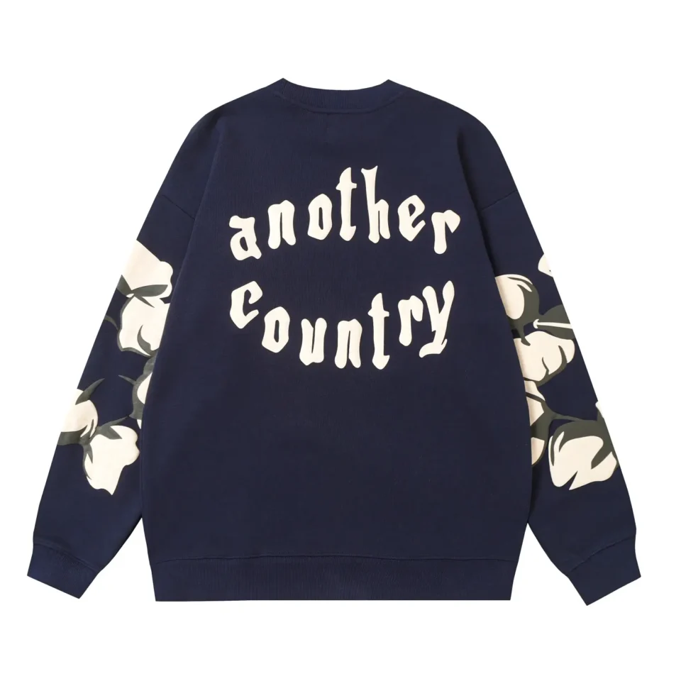 Another Country sweatshirt navy blue cotton with white floral sleeve prints and graphic back text design