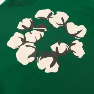 Cotton flower graphic design on a green hoodie from Denim Tears, highlighting trendy apparel features.