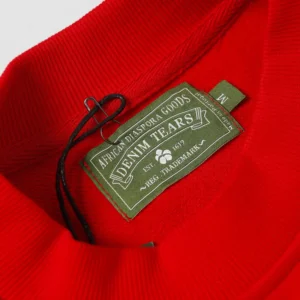 Denim Tears crewneck sweatshirt red cotton fabric with green sewn-in brand label and black string tag