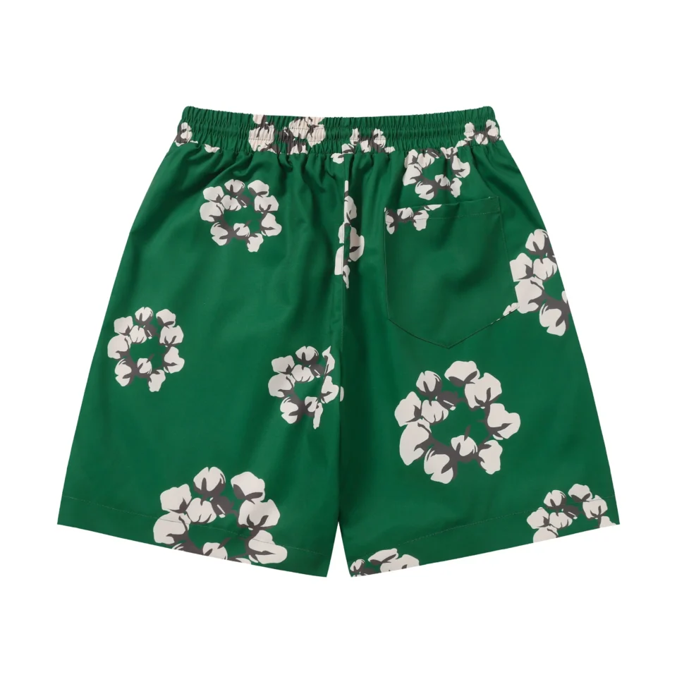 No brand visible, green shorts with white floral print and elastic waistband made of synthetic fabric