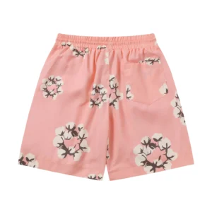Pink cotton shorts featuring a floral cotton flower print, showcasing the Denim Tears brand style.