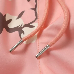 Close-up of pink fabric with floral design and drawstring details, showcasing Denim Tears Cotton Flower shorts.