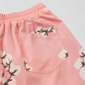 Pink shorts featuring a cotton flower design and a back pocket, representing Denim Tears Cotton Flower European and American Tide product.