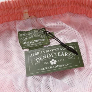 Pink mesh fabric with Denim Tears tag, featuring "African Diasporas" branding and established date 1619.