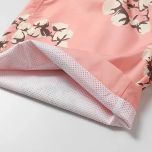 Cotton Flower shorts by Denim Tears, featuring a floral design in pink and brown, showcasing the hem and inner lining details.