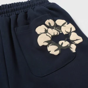 Denim Tears Cotton Flowers Printed Shorts featuring foam flocking design on navy fabric, showcasing cotton flower graphics on pocket.
