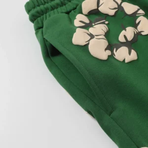 Green shorts featuring cotton flower graphic print, part of Denim Tears New Cotton Flowers collection, emphasizing trendy design and quality.