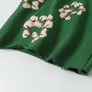 Green shorts featuring cotton flower prints, showcasing trendy design and high-quality fabric, part of the Denim Tears collection.