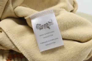 Denim Tears clothing tag beige fabric 100% cotton made in Portugal