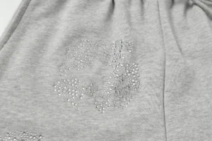 No brand or model information visible for this gray fabric with crystal embellishment detail.