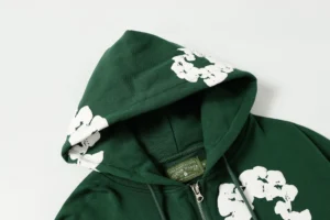 DENIM TEARS Cotton Flower hooded sweatshirt in green with white floral print, showcasing zipper detail and fabric texture.