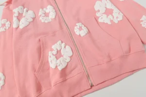 DENIM TEARS Cotton Flower hoodie in pink with white floral foam prints, featuring a zipper design, showcasing high-quality fabric and stylish aesthetics.