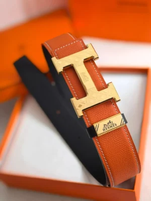Hermes belt orange leather gold-tone metal H buckle luxury accessory with signature logo engraving