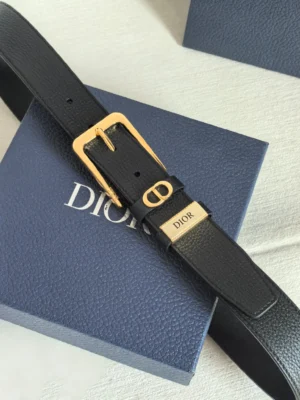 Dior Unisex CD Logo Leather Belt featuring a gold-tone buckle with "CD" logo, displayed on a blue Dior box, emphasizing luxury and brand recognition.
