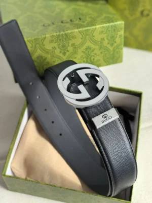 Gucci men's leather belt featuring a double G logo buckle, presented in a green box, showcasing high-quality craftsmanship and brand recognition.