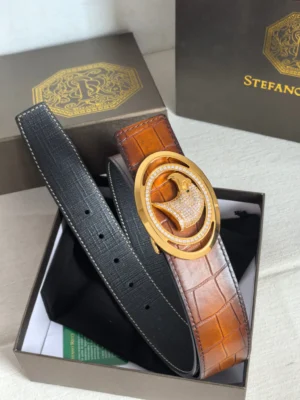 Luxury Stefano Ricci men's leather belt featuring a gold and diamond buckle, displayed in a branded box with a black and brown strap.